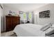 Bedroom with hardwood dresser, sports equipment, and a comfortable bed at 527 English Sparrow Trl, Highlands Ranch, CO 80129