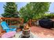 Cozy outdoor deck with a fire pit, chairs, potted plants, and a grill, perfect for entertaining at 527 English Sparrow Trl, Highlands Ranch, CO 80129