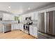 Modern kitchen featuring stainless steel appliances, granite countertops, and white cabinetry at 527 English Sparrow Trl, Highlands Ranch, CO 80129