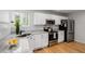 Modern kitchen with stainless steel appliances, granite countertops, and white cabinetry at 527 English Sparrow Trl, Highlands Ranch, CO 80129