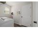 Clean laundry room with washer, dryer, ample storage, and bright natural light from the window at 527 English Sparrow Trl, Highlands Ranch, CO 80129