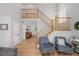 Bright and open living room with a staircase, hardwood floors, and comfortable seating at 527 English Sparrow Trl, Highlands Ranch, CO 80129