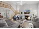 Spacious living room with high ceilings, fireplace, comfortable seating, and staircase at 527 English Sparrow Trl, Highlands Ranch, CO 80129