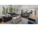 Bright living room with comfortable seating, a view into the kitchen and sliding glass door at 527 English Sparrow Trl, Highlands Ranch, CO 80129