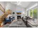 Spacious living room with comfortable seating, fireplace, large windows, and a staircase at 527 English Sparrow Trl, Highlands Ranch, CO 80129