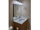 Bathroom with a single vanity, marble countertop, framed mirror and brushed chrome fixtures at 9105 E Lehigh Ave # 105, Denver, CO 80237