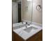 Bathroom with a single vanity, marble countertop, framed mirror and brushed chrome fixtures at 9105 E Lehigh Ave # 105, Denver, CO 80237