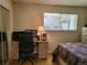Bedroom area offering a built-in desk, providing a practical workspace with abundant natural light at 9105 E Lehigh Ave # 105, Denver, CO 80237