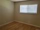 Bright, cozy bedroom with hardwood floors and a large window for natural light at 9105 E Lehigh Ave # 105, Denver, CO 80237