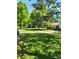 Scenic common area features lush green lawn, mature trees, and walkways for relaxing outdoor enjoyment at 9105 E Lehigh Ave # 105, Denver, CO 80237