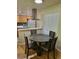 Cozy dining area featuring a round table and chairs, adjacent to the kitchen for easy access at 9105 E Lehigh Ave # 105, Denver, CO 80237