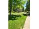 Lush green space with mature trees and a sidewalk, creating a serene neighborhood setting at 9105 E Lehigh Ave # 105, Denver, CO 80237