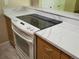 Kitchen cooktop with stylish marble-style countertops and updated appliances at 9105 E Lehigh Ave # 105, Denver, CO 80237