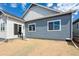 New home featuring a patio and backyard with blue siding and bright white trim around the windows at 8245 Cokedale Cir, Littleton, CO 80125