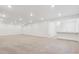 Spacious basement with recessed lighting, offering a versatile living area adjacent to a kitchen prep area at 8245 Cokedale Cir, Littleton, CO 80125