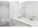 Bathroom featuring a double sink vanity, sleek white cabinets and large mirrors, with a toilet and shower to the side at 8245 Cokedale Cir, Littleton, CO 80125