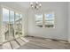Bright dining room with a large sliding glass door and light gray flooring at 8245 Cokedale Cir, Littleton, CO 80125