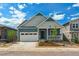 Charming blue two-story home featuring an attached garage and welcoming front porch at 8245 Cokedale Cir, Littleton, CO 80125