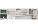 Bright kitchen with white cabinets, a large island, and stainless steel appliances at 8245 Cokedale Cir, Littleton, CO 80125