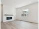Bright living room with a modern fireplace and large window at 8245 Cokedale Cir, Littleton, CO 80125