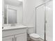White tiled shower with a glass door, designed to provide a seamless and luxurious showering experience at 8245 Cokedale Cir, Littleton, CO 80125