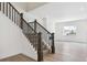 Bright staircase with dark wood railing and light gray flooring at 8245 Cokedale Cir, Littleton, CO 80125