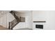 Bright staircase with dark wood railing, an open living room, and a modern fireplace at 8245 Cokedale Cir, Littleton, CO 80125