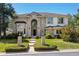Inviting two-story brick home featuring manicured lawn and arched entry, enhancing curb appeal at 72 Falcon Hills Dr, Highlands Ranch, CO 80126