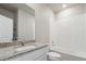 A well-lit bathroom featuring a granite countertop, a sink, and a shower-tub combination at 5913 Sawdust Dr, Brighton, CO 80601