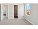 Carpeted bedroom with ample natural light and closet access at 5913 Sawdust Dr, Brighton, CO 80601
