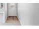 Bright entryway featuring a wood floor transition and a frosted glass front door at 5913 Sawdust Dr, Brighton, CO 80601