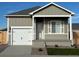 Charming single-story home featuring a one-car garage and neutral-colored siding at 5913 Sawdust Dr, Brighton, CO 80601