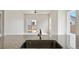 Open concept kitchen with stainless steel faucet and granite countertops at 5913 Sawdust Dr, Brighton, CO 80601