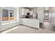 Open concept living room with a window seat area and view of the kitchen at 5913 Sawdust Dr, Brighton, CO 80601