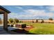 Secluded backyard featuring a hot tub and expansive grassy area with views of the surrounding landscape at 953 Compass Dr, Erie, CO 80516