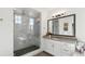 Luxury bathroom featuring a spacious glass shower, granite vanity, and designer fixtures at 953 Compass Dr, Erie, CO 80516