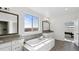 Elegant bathroom with a soaking tub, double vanity, and scenic window views at 953 Compass Dr, Erie, CO 80516