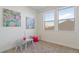 Bright bedroom featuring a small table with chairs and two large windows at 953 Compass Dr, Erie, CO 80516