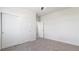 Empty bedroom featuring a closet with sliding doors and neutral carpeting throughout at 953 Compass Dr, Erie, CO 80516