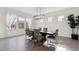 Elegant dining room featuring modern light fixture and large windows with sheer curtains for natural light at 953 Compass Dr, Erie, CO 80516