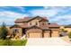 Stunning two-story home showcasing a stone and siding exterior with a spacious three-car garage at 953 Compass Dr, Erie, CO 80516