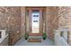 Inviting front entryway featuring a glass door, decorative wreaths and stylish brickwork at 953 Compass Dr, Erie, CO 80516