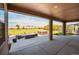 Covered patio with outdoor seating overlooking a spacious backyard and landscape at 953 Compass Dr, Erie, CO 80516