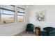 Bright sitting area with two armchairs, chandelier, and a picturesque view from the windows at 953 Compass Dr, Erie, CO 80516