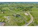 Aerial view of a property surrounded by expansive green fields and neighborhood at 46093 Bristlecone Ct, Parker, CO 80138