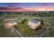 Gorgeous home with a white fence, lush green lawn, barn, and play area in the backyard at 46093 Bristlecone Ct, Parker, CO 80138