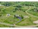 Stunning aerial view of sprawling estate with lush greenery and a long driveway at 46093 Bristlecone Ct, Parker, CO 80138