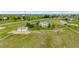 Aerial view of the home on a sprawling green property surrounded by a white fence at 46093 Bristlecone Ct, Parker, CO 80138
