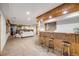 Spacious basement features a living area, bar, fireplace, and wood accents at 46093 Bristlecone Ct, Parker, CO 80138