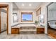 Bright bathroom features a soaking tub, and custom wooden cabinets at 46093 Bristlecone Ct, Parker, CO 80138